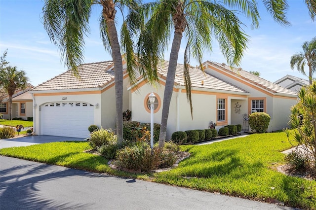 view of front of house with a front yard and a garage