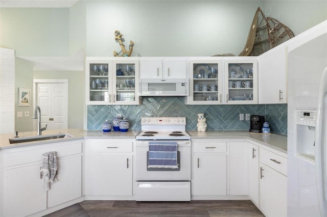 kitchen featuring white appliances, sink, dark hardwood / wood-style floors, and white cabinets