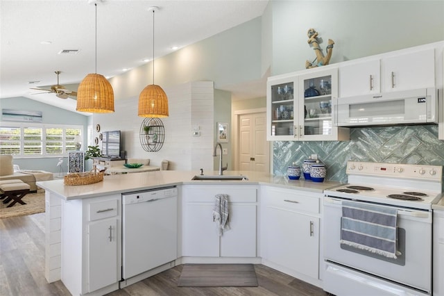 kitchen with white cabinetry, sink, vaulted ceiling, and white appliances