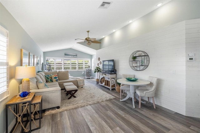 living room featuring ceiling fan, hardwood / wood-style flooring, and vaulted ceiling