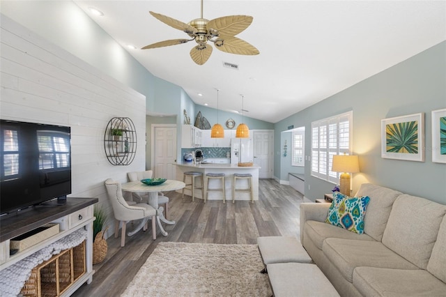 living room featuring ceiling fan, lofted ceiling, and dark hardwood / wood-style floors