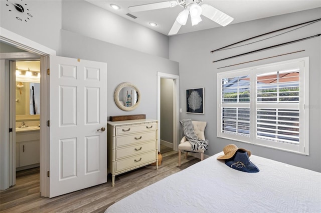 bedroom featuring connected bathroom, hardwood / wood-style floors, sink, and ceiling fan