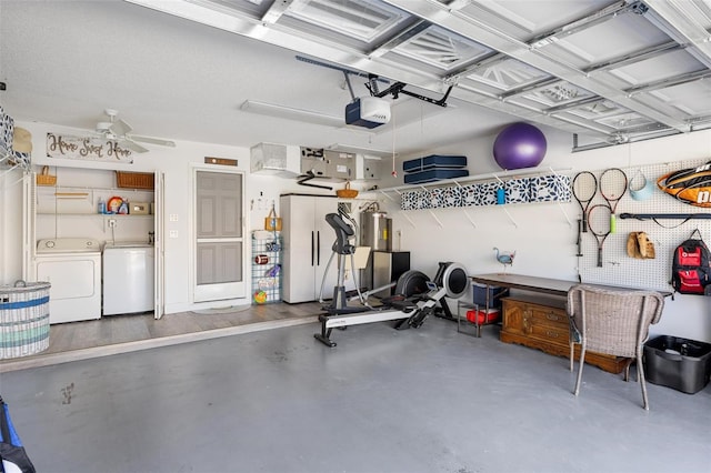 garage featuring a garage door opener, independent washer and dryer, a workshop area, and ceiling fan