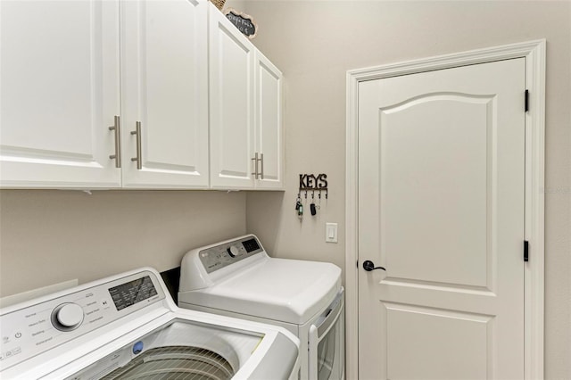 laundry area featuring cabinets and separate washer and dryer