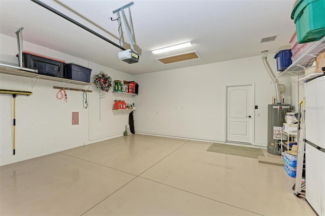 garage featuring a garage door opener and water heater