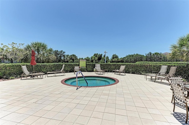 view of pool with a patio and a community hot tub