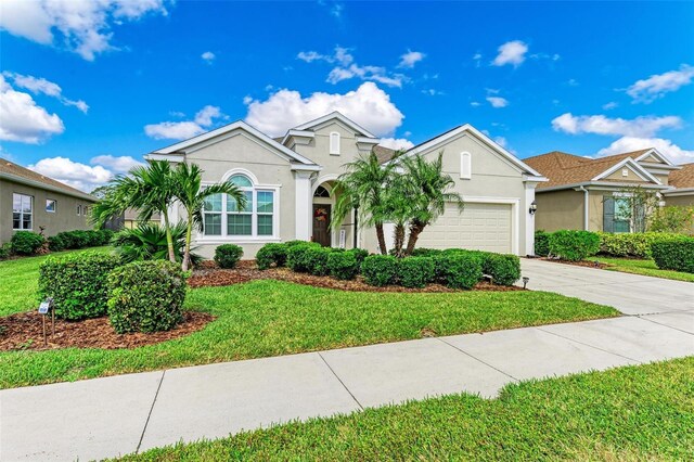12715 Lake Silver Ave, Bradenton, FL 34211 - view of front of house featuring a front yard and a garage