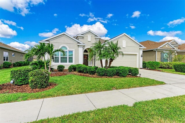 view of front of house featuring a front yard and a garage