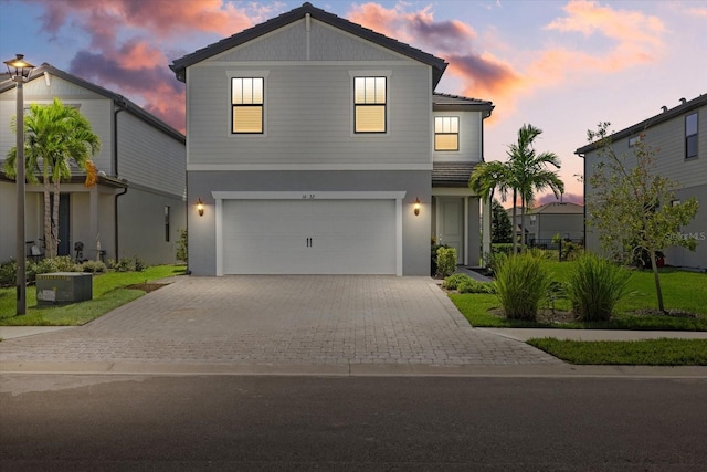 view of front of property with central AC and a garage