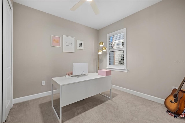 home office featuring light carpet and ceiling fan