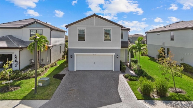 view of front of house featuring a front yard and a garage