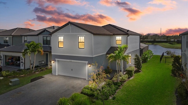 view of front of house featuring a yard and a garage