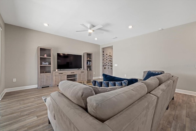 living room featuring light wood-type flooring and ceiling fan