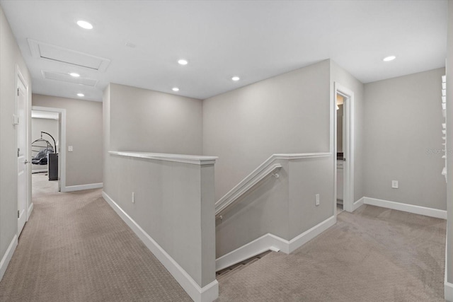 hallway featuring light colored carpet