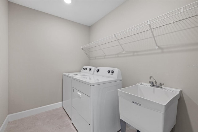 laundry area featuring washer and dryer and sink