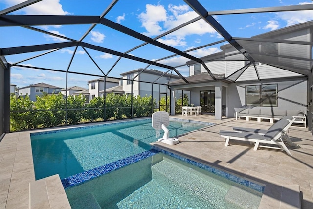 view of swimming pool featuring a patio area and glass enclosure