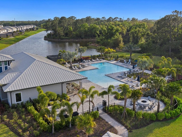 view of swimming pool with a patio and a water view