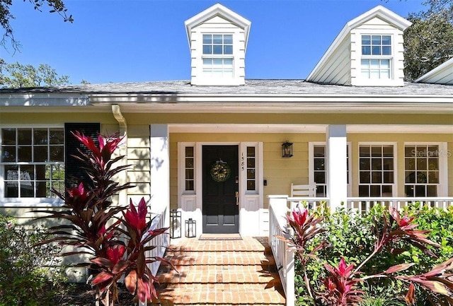 entrance to property featuring covered porch