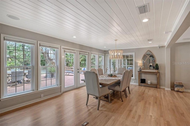 dining area with a wealth of natural light, french doors, light wood-style floors, and visible vents