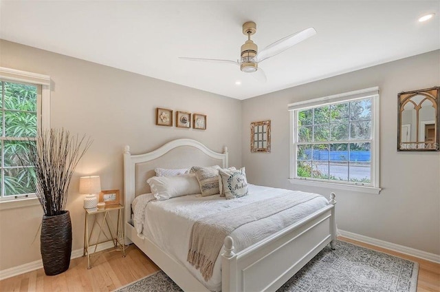 bedroom with ceiling fan and wood-type flooring