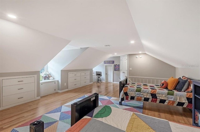 bedroom with light hardwood / wood-style flooring and lofted ceiling