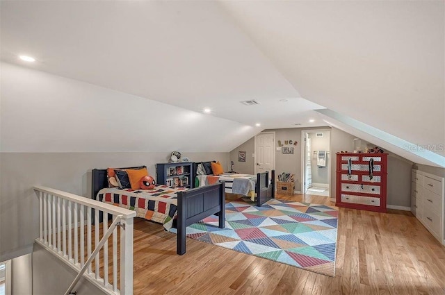 interior space featuring light hardwood / wood-style floors and lofted ceiling