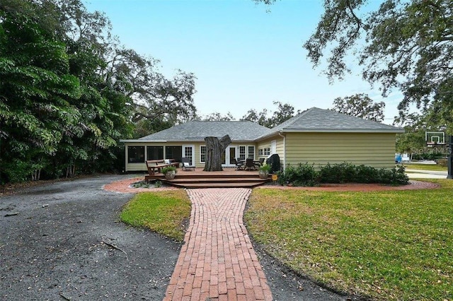 ranch-style house with a front lawn