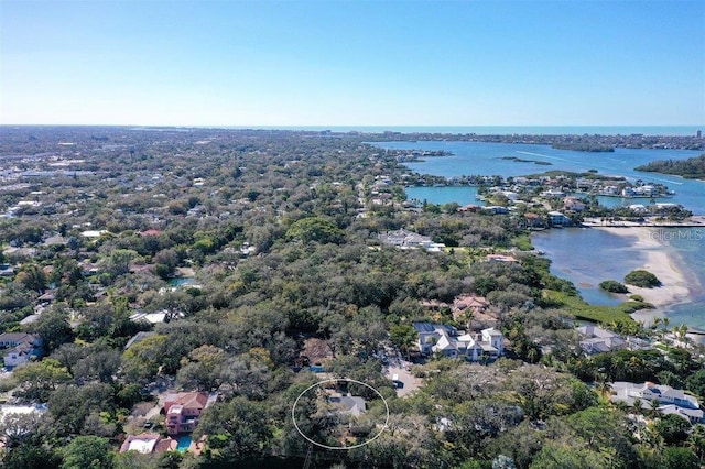birds eye view of property featuring a view of trees and a water view
