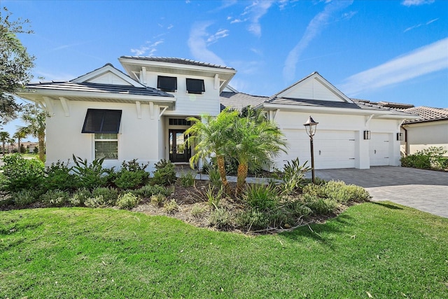 view of front of house with a front lawn and a garage