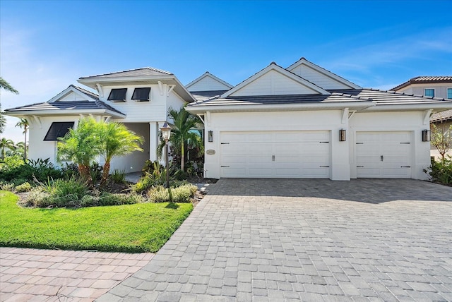 view of front of home featuring a front yard and a garage