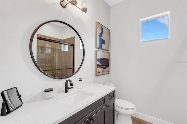 bathroom with vanity, toilet, wood-type flooring, and an enclosed shower