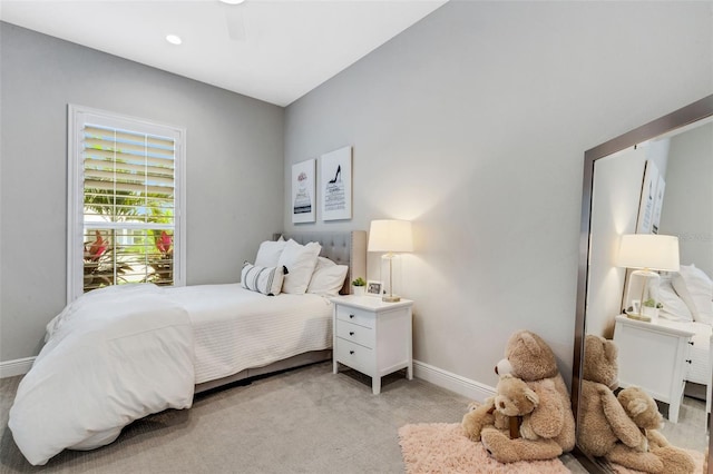 bedroom with ceiling fan and light carpet