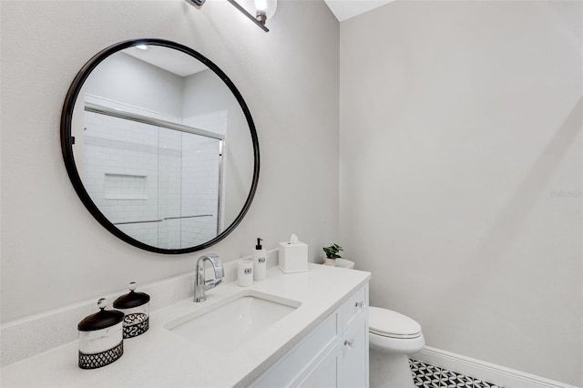 bathroom with vanity, toilet, and an enclosed shower