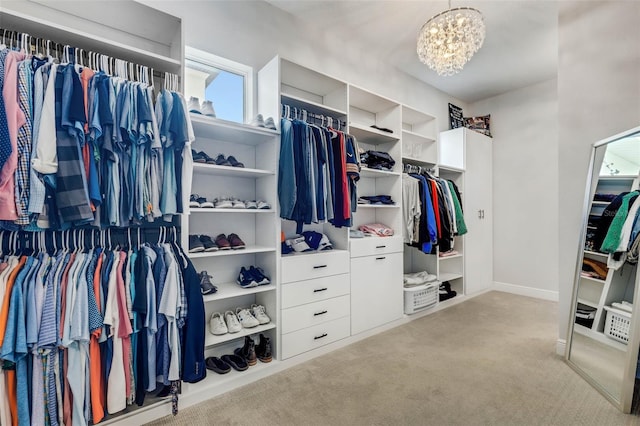 spacious closet with light carpet and a notable chandelier