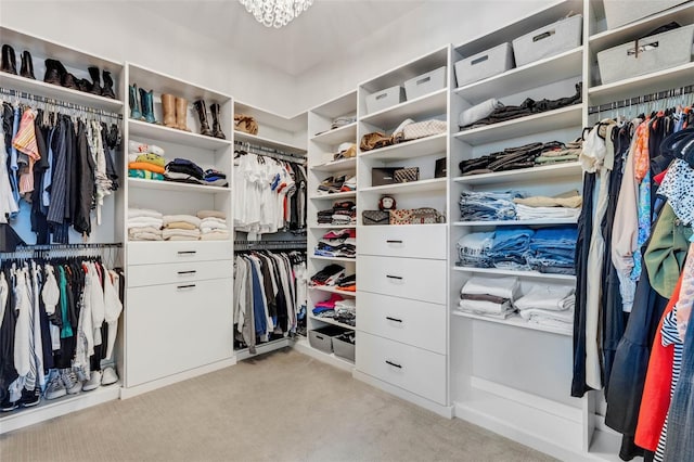 walk in closet featuring light carpet