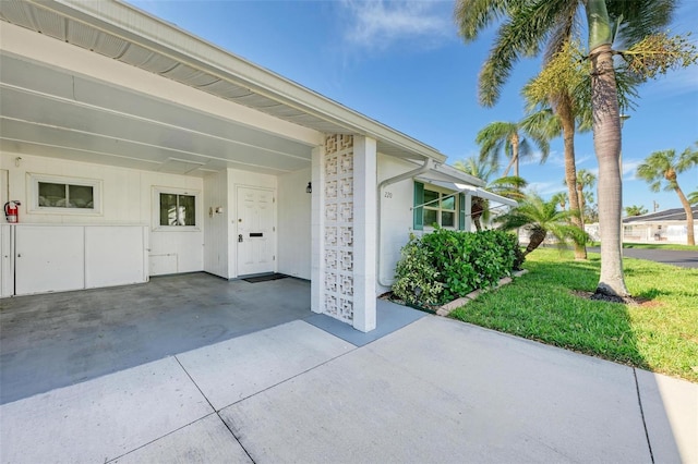 view of exterior entry with a yard