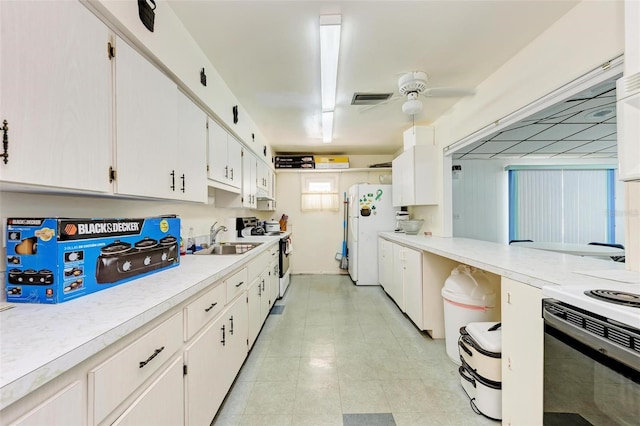 kitchen featuring sink, white cabinetry, white appliances, and ceiling fan