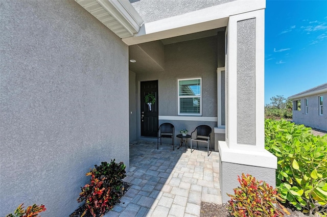 view of exterior entry featuring a patio