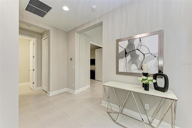 hallway featuring light tile patterned floors