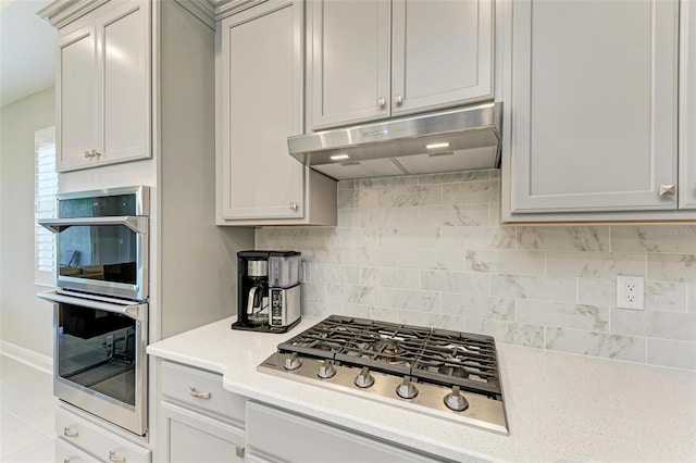 kitchen with tasteful backsplash and stainless steel appliances