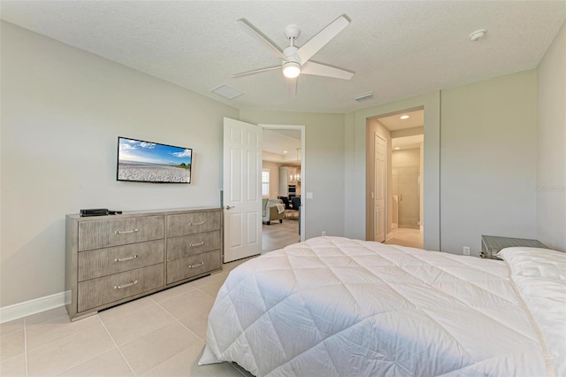 bedroom featuring a textured ceiling, light tile patterned floors, and ceiling fan