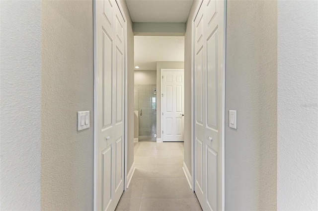 hall with light tile patterned flooring