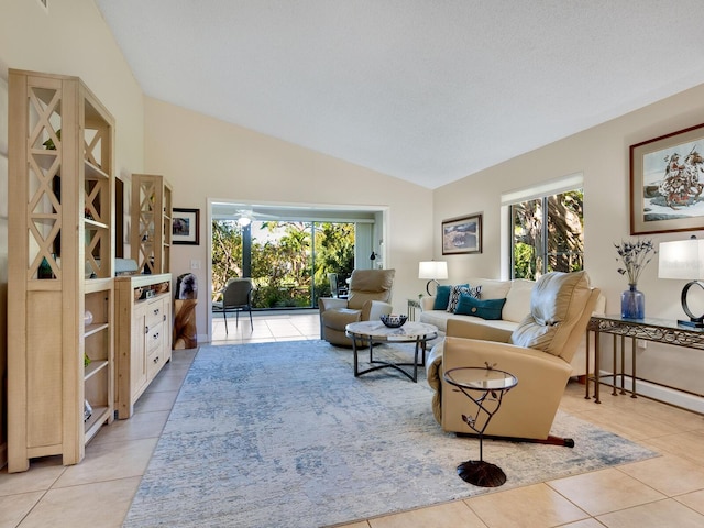 tiled living room with vaulted ceiling, a textured ceiling, and plenty of natural light