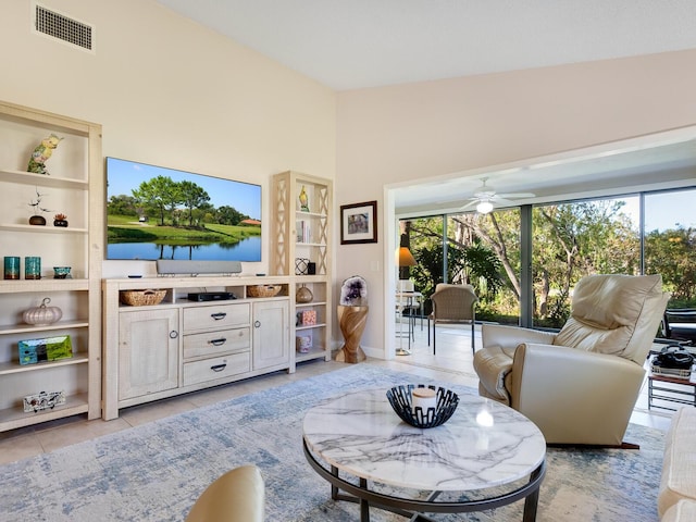 6417 Meadowlark Ln Unit 6417, Bradenton, FL 34210 - living area with a high ceiling, built in features, a ceiling fan, light tile patterned floors, and visible vents