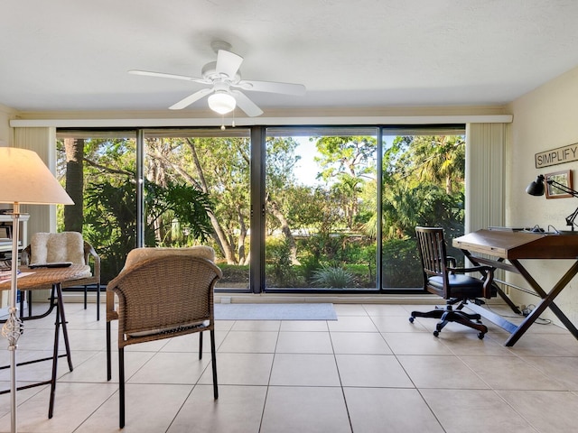 sunroom featuring ceiling fan and a healthy amount of sunlight