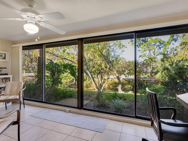 doorway with light tile patterned floors and ceiling fan