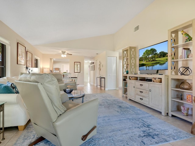 tiled living room featuring lofted ceiling and ceiling fan