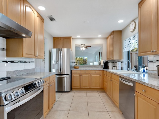 6417 Meadowlark Ln Unit 6417, Bradenton, FL 34210 - kitchen with wall chimney range hood, ceiling fan, appliances with stainless steel finishes, light countertops, and visible vents