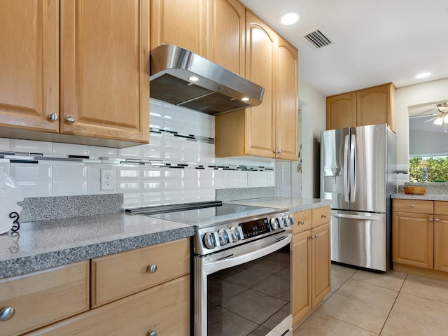 kitchen with light brown cabinetry, extractor fan, appliances with stainless steel finishes, and light tile patterned floors