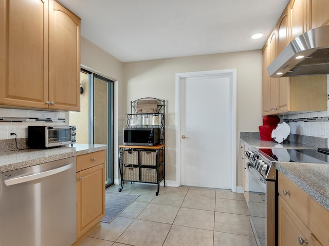 6417 Meadowlark Ln Unit 6417, Bradenton, FL 34210 - kitchen with decorative backsplash, light brown cabinetry, light tile patterned floors, under cabinet range hood, and stainless steel appliances